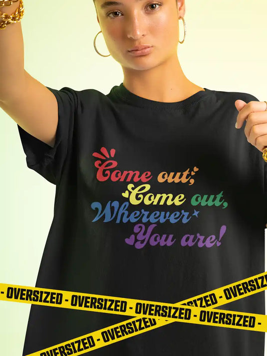 Woman wearing Black Oversized Cotton Tshirt with quote "Come out Come out wherever you are" in PRIDE colors