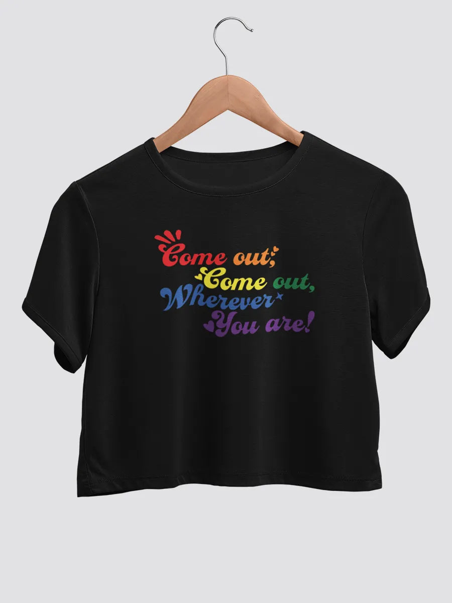 Black cotton crop top with LGBTQ quote "Come out come out wherever you are" The Text is in LGBTQ pride colors