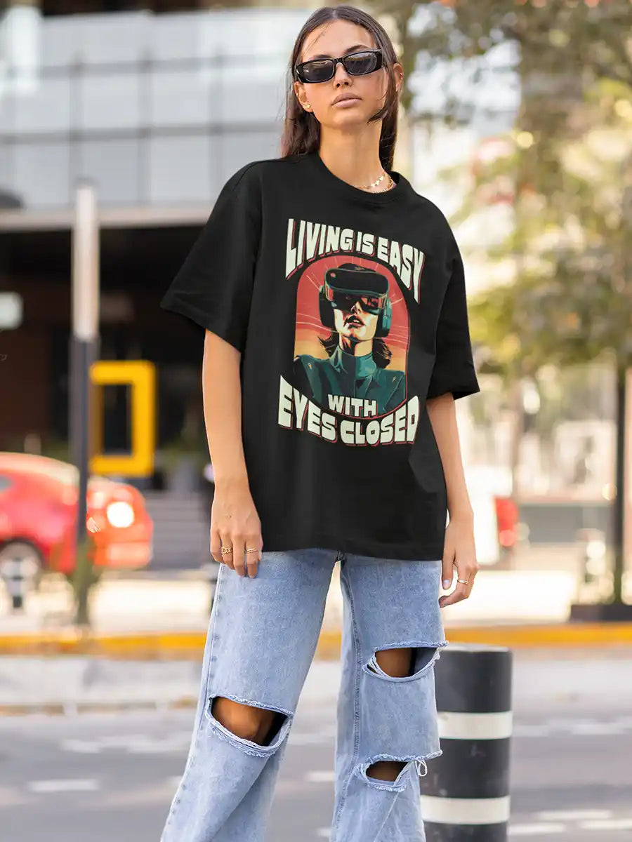 Woman wearing Living is EASY with eyes Closed - Black  Oversized T-Shirt
