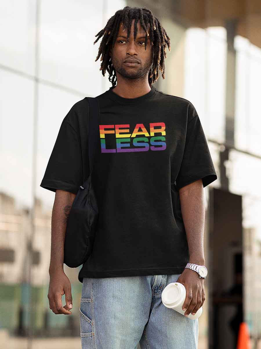 Man wearing Black Oversized Cotton Tshirt with quote "Fearless" in PRIDE colors