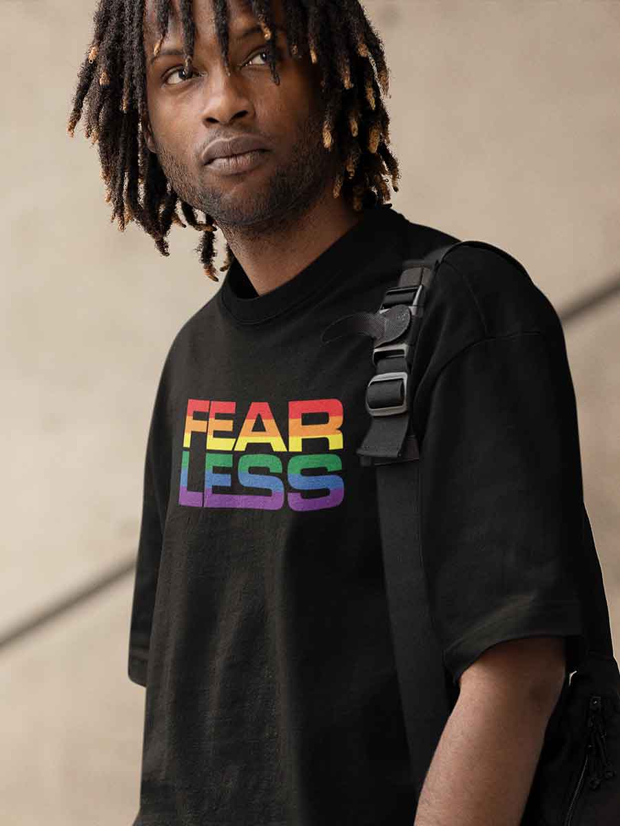 Man wearing Black Oversized Cotton Tshirt with quote "Fearless" in PRIDE colors