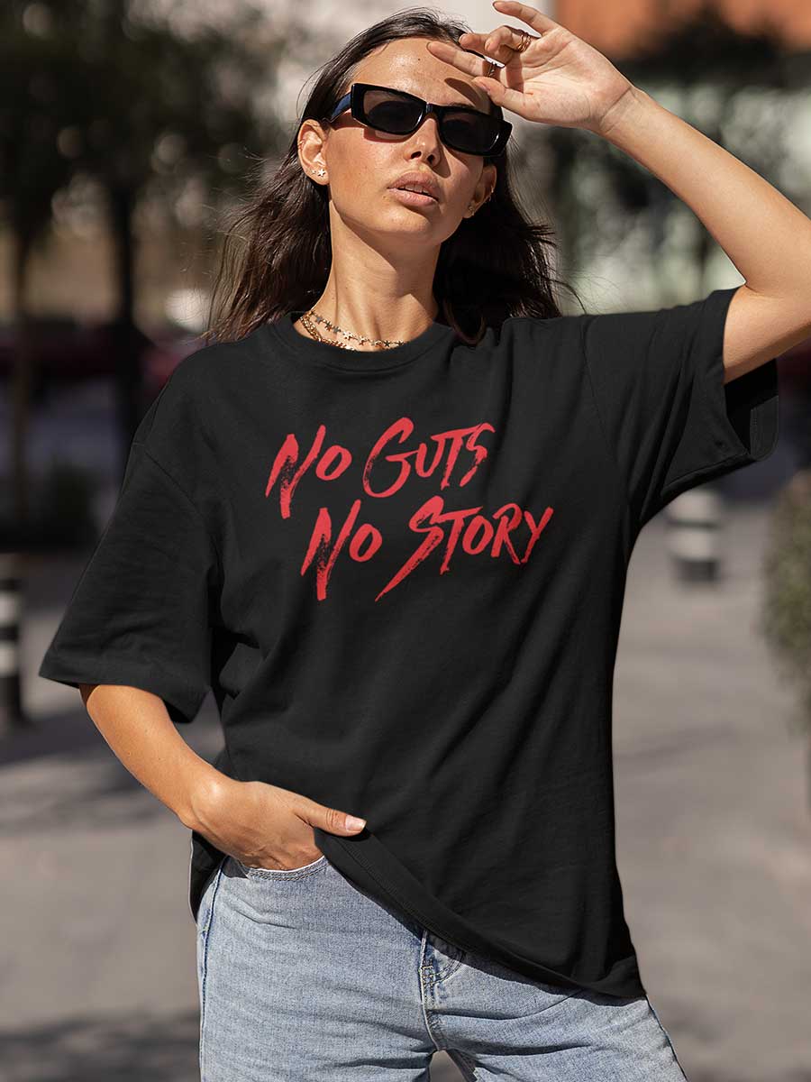 Woman wearing Black Oversized Cotton Tshirt with text "No Guts No Story" in Red