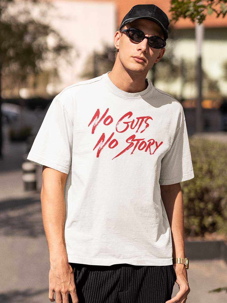 Man wearing White Oversized Cotton Tshirt with text "No Guts No Story" in Red