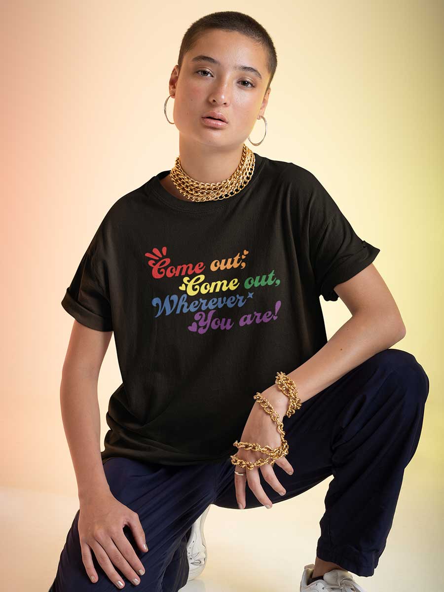 Woman wearing Black Oversized Cotton Tshirt with quote "Come out Come out wherever you are" in PRIDE colors