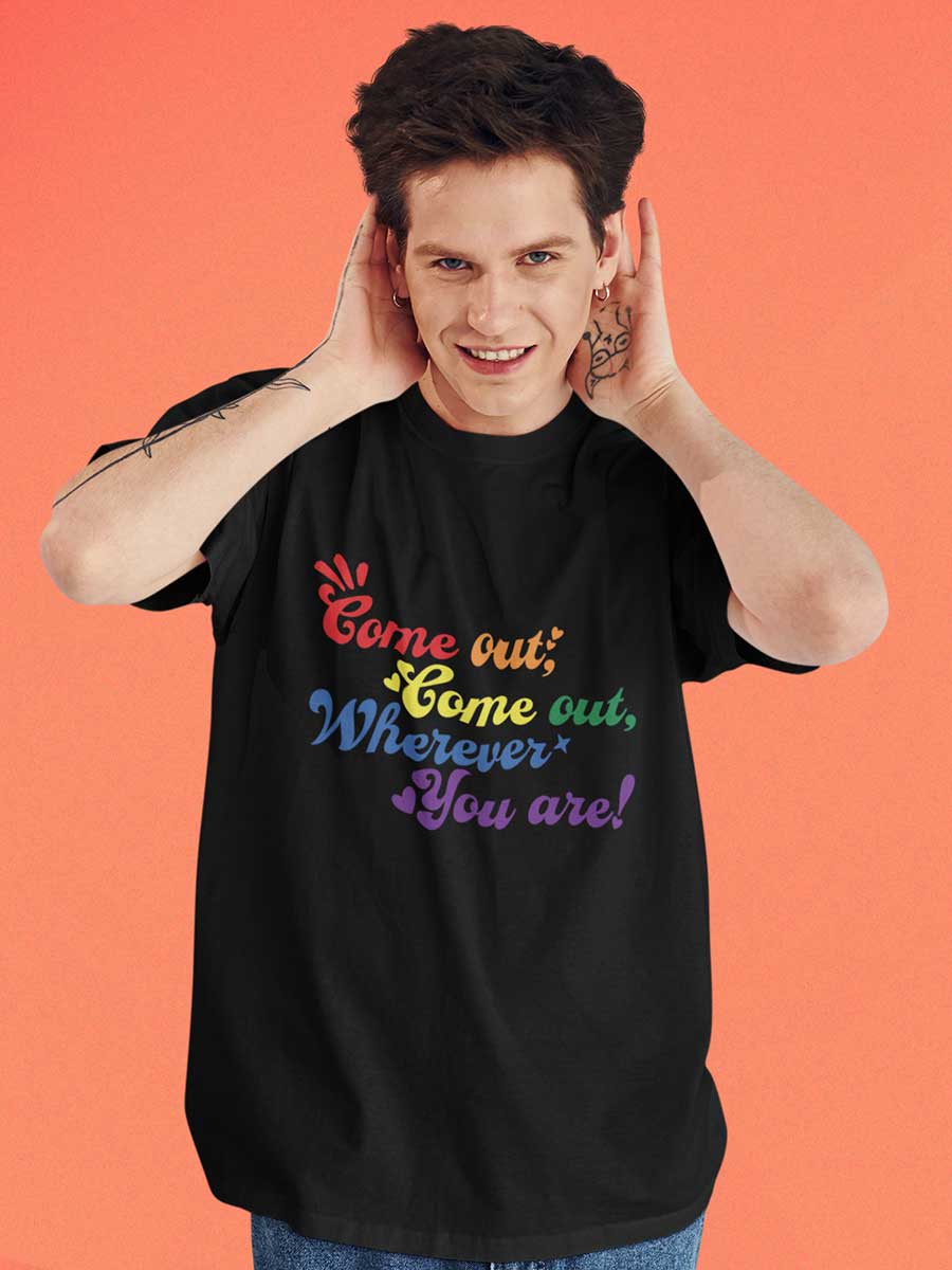 Man wearing Black Oversized Cotton Tshirt with quote "Come out Come out wherever you are" in PRIDE colors